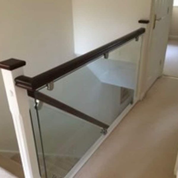 Staircase Refurbishment Southampton 55 Glass staircase balustrade with dark handrail and white newel post