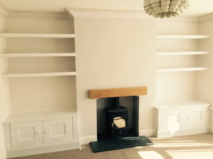 Bespoke fitted alcove shelving and cupboards either side of a fireplace, Southampton